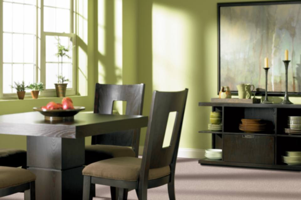 Lime Cream walls in dining room with greige carpet and dark wood dining set and Lime Cream Decor.